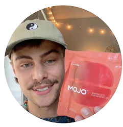 Person holding a red package labeled 'MOJO' with a yin-yang cap.