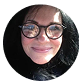 A person with glasses smiling in a circular frame.