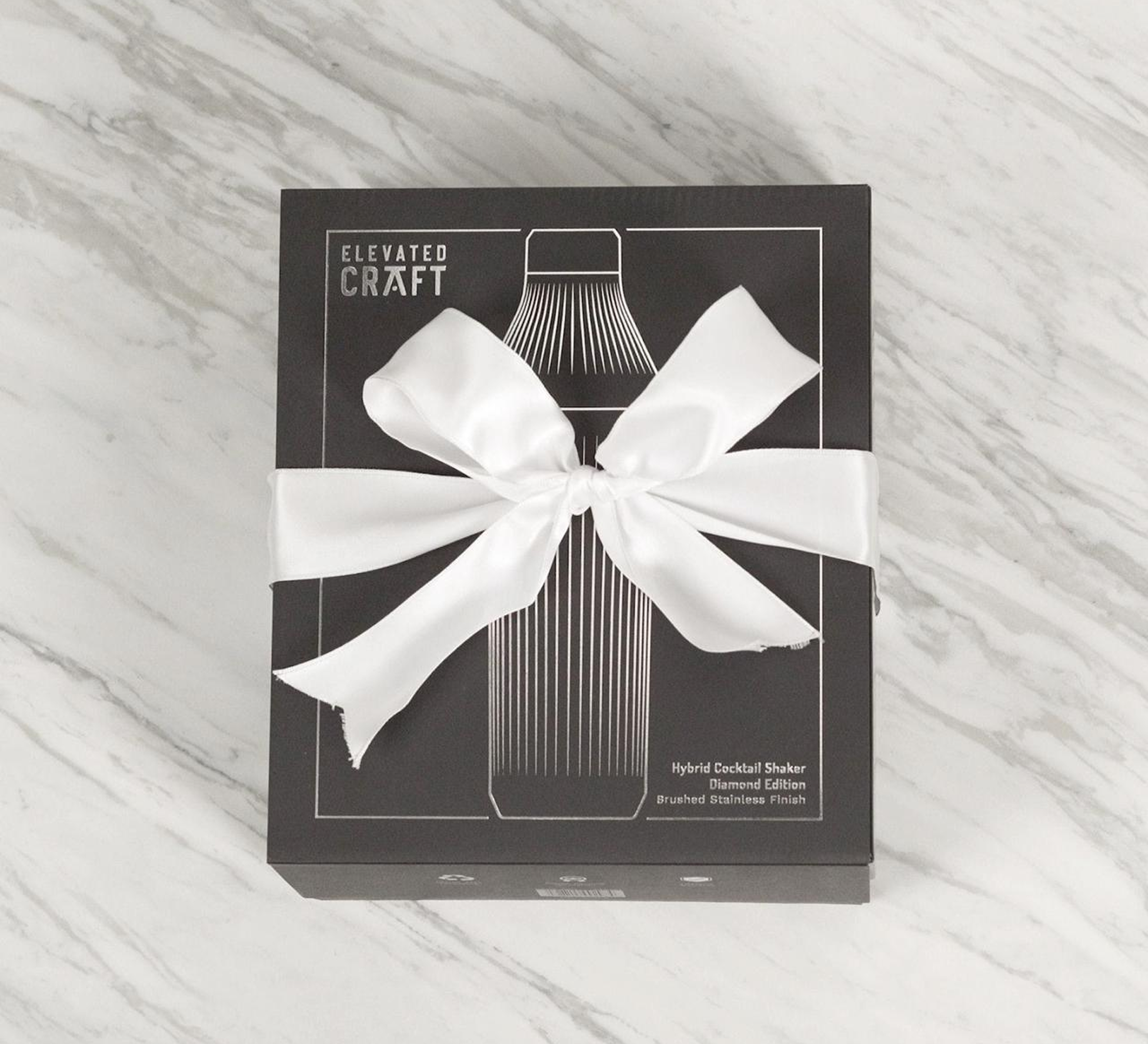 Black box with a white ribbon, labeled 'Elevated Craft' and cocktail shaker design.
