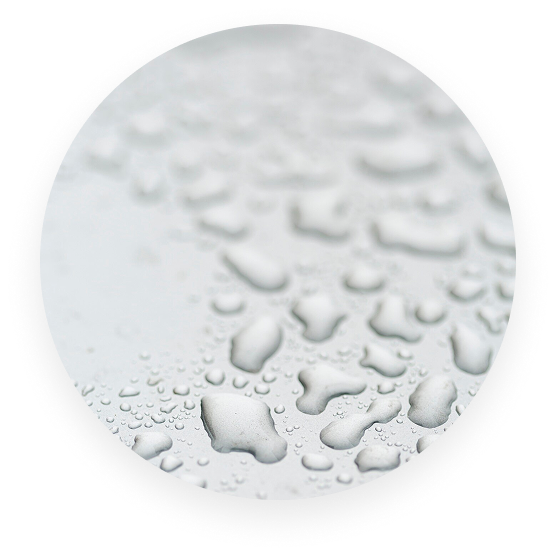 Close-up view of raindrops on a smooth surface.