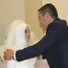 A bride and groom embracing indoors.