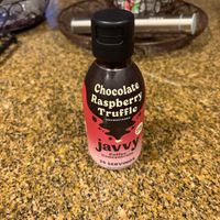 Small bottle labeled 'Chocolate Raspberry Truffle' on a granite countertop.