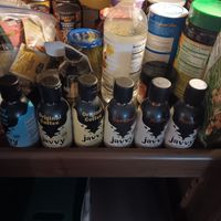 Shelf with various bottles and containers, including several labeled 'Javvy.'