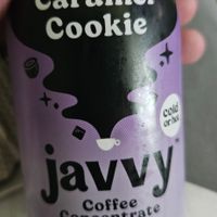 Purple bottle labeled 'Caramel Cookie Javvy Coffee Concentrate' with decorative icons.