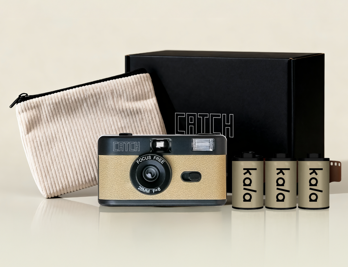 A black and tan film camera kit including three rolls of film, a pouch, and a box.