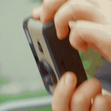Hands playing with a rotating toy puzzle.