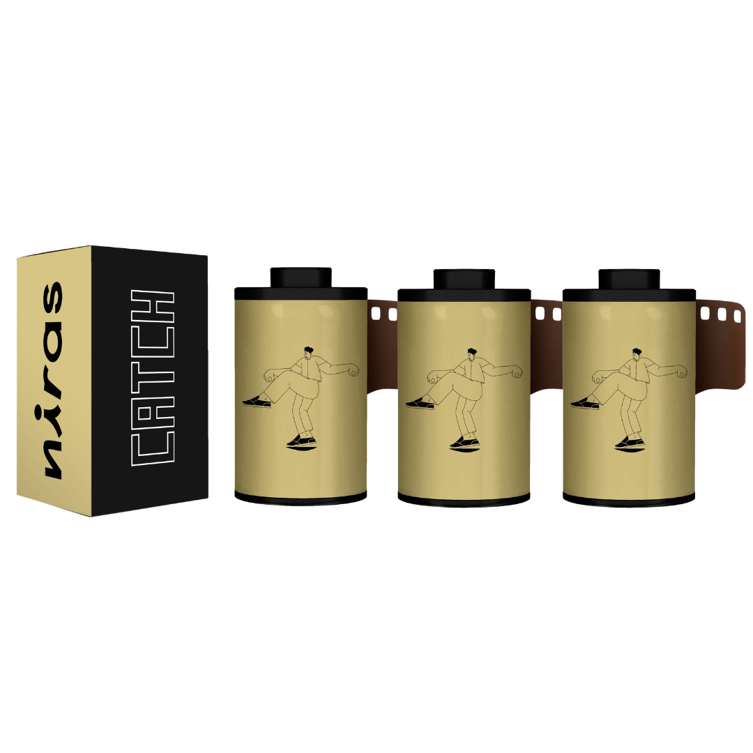 A product shot of a box labeled 'niras CATCH' next to three matching rolls of 35mm film.