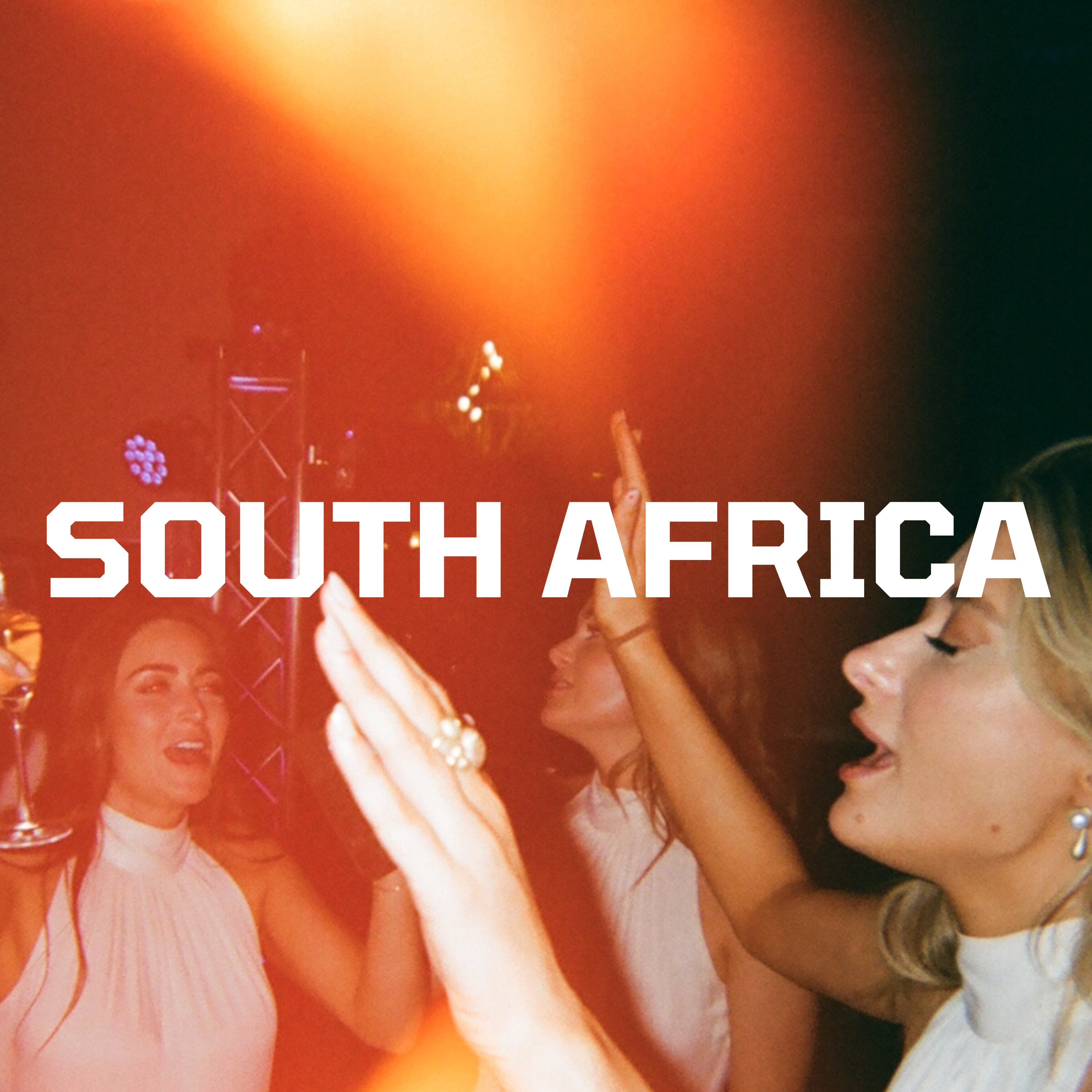 Three people dancing under bright lights, with 'South Africa' text overlay.