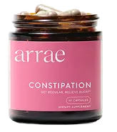 Glass jar labeled 'constipation' with capsule supplements inside.
