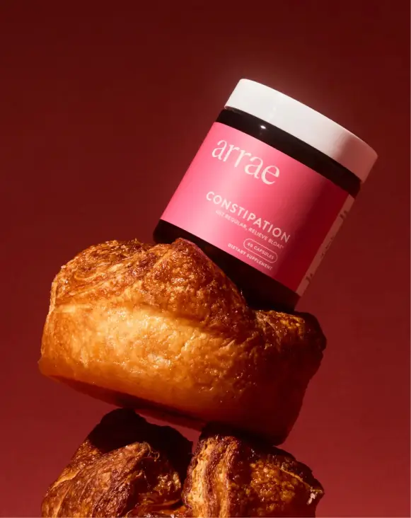 A jar labeled 'arrae' on top of a pastry against a red background.