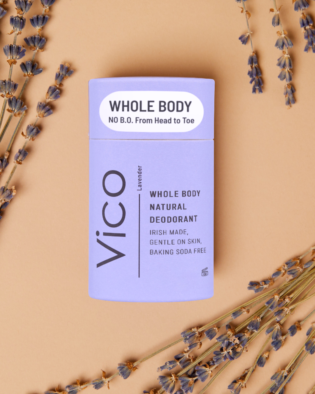 A purple tube of VICO lavender deodorant is arranged with dried lavender sprigs on a tan background.