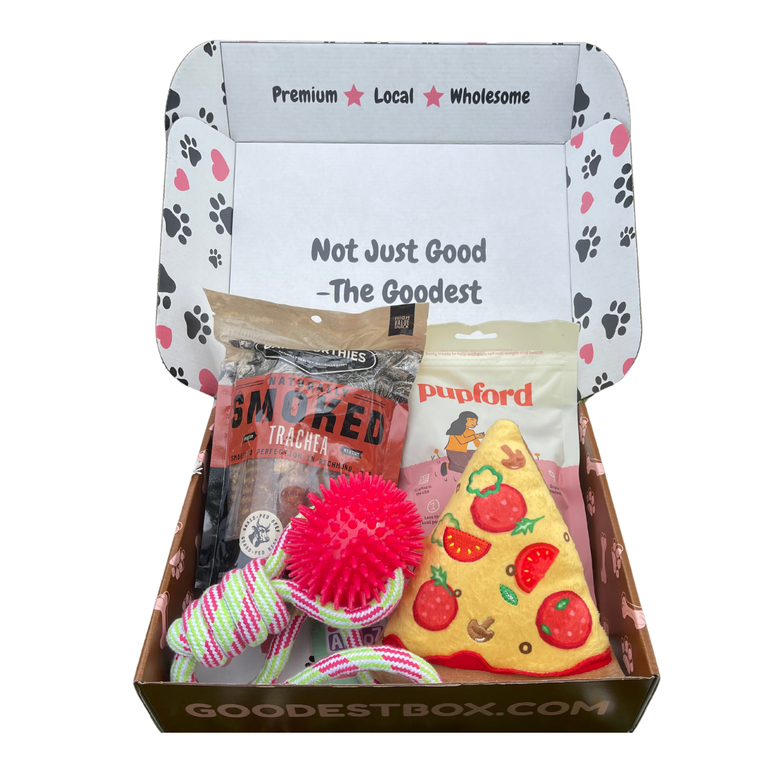 Open box with dog treats and toys, labeled 'Not Just Good - The Goodest.'