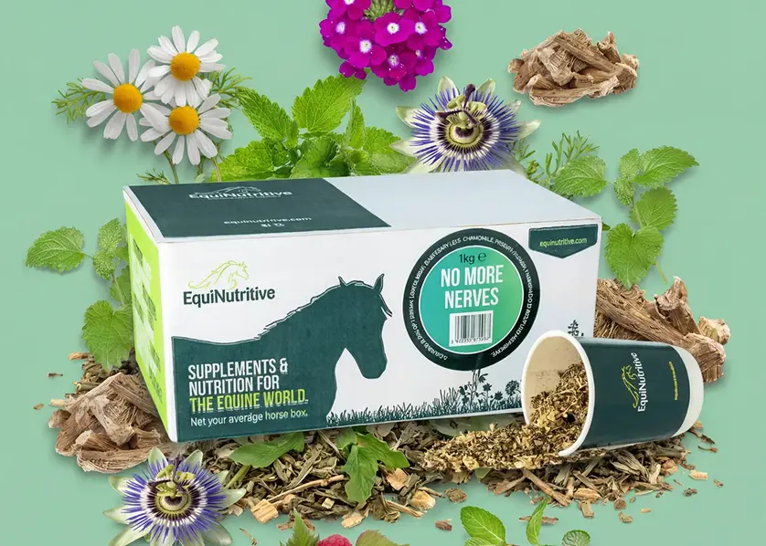 A box of EquiNutritive horse supplements surrounded by various flowers, herbs, and the loose product mix.