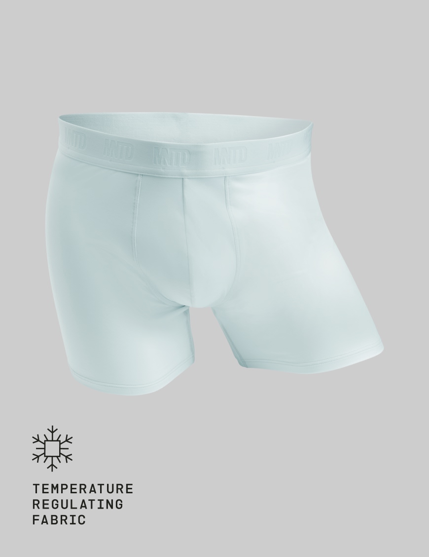 A pair of light blue MNTD boxer briefs shown against a solid grey background.