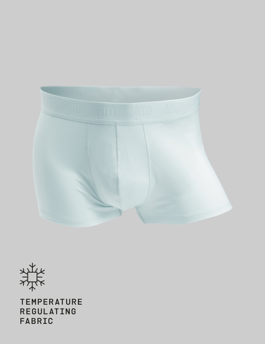 A pair of light blue boxer briefs with a branded waistband against a grey background.