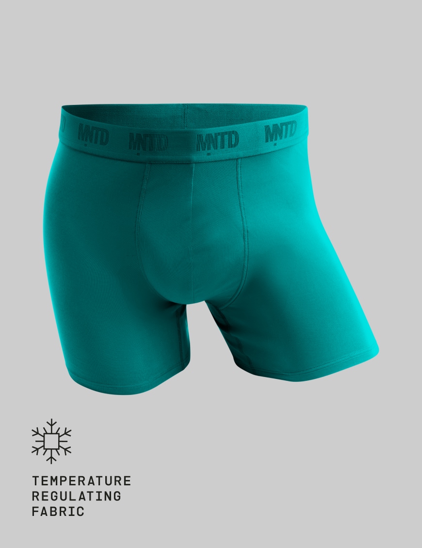 A pair of teal MNTD boxer briefs against a plain grey background.