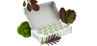 An open white box labeled 'EatHealthy' with green pods inside, surrounded by fresh leafy greens.
