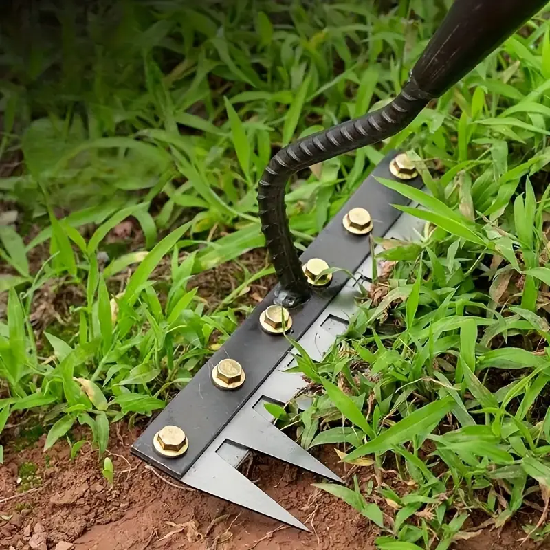 Garden tool with metal spikes used on grass and soil.