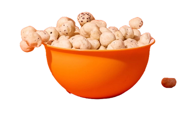 Orange bowl filled with popped water lily seeds on orange background