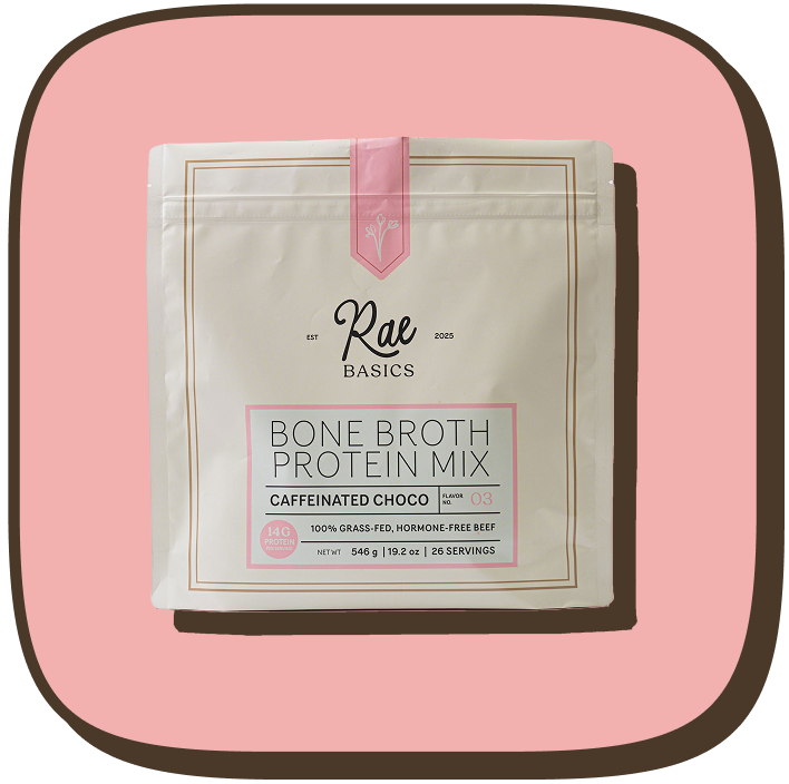 A white and pink pouch of Rae Basics Caffeinated Choco Bone Broth Protein Mix on a pink background.