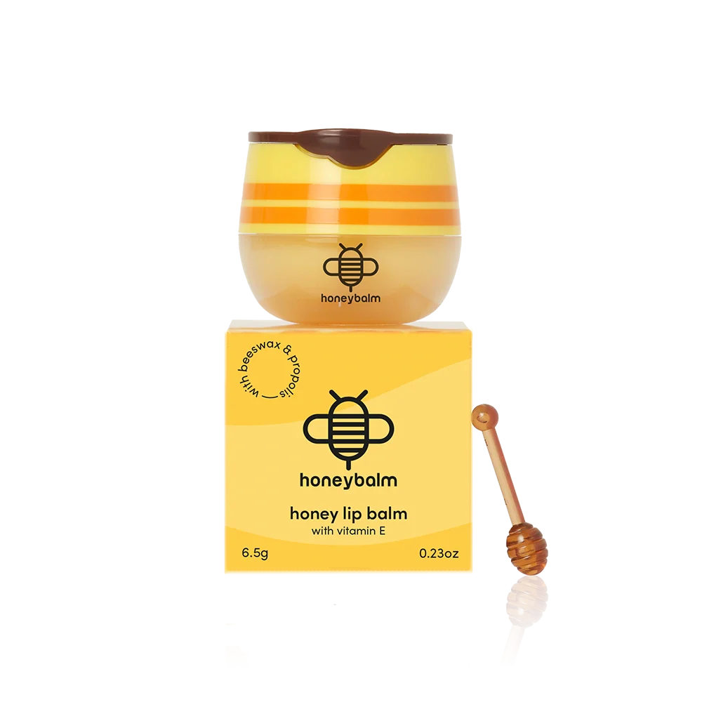 Yellow honey-themed lip balm with a box and dipper.