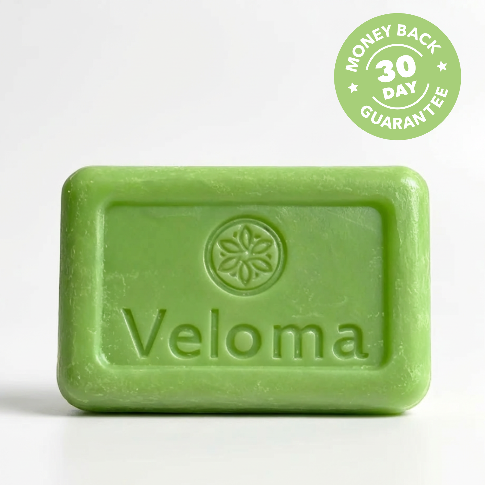 A light green bar of Veloma soap with a 30-day money-back guarantee badge.