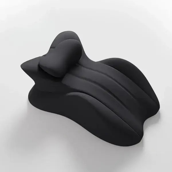 A black, ergonomically shaped neck and back support pillow on a plain white surface.