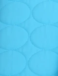 A close-up of light blue quilted fabric with a repeating oval pattern.