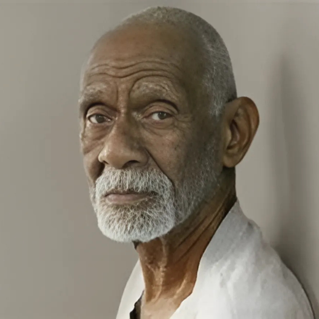 Elderly man with a white beard looking into the camera.