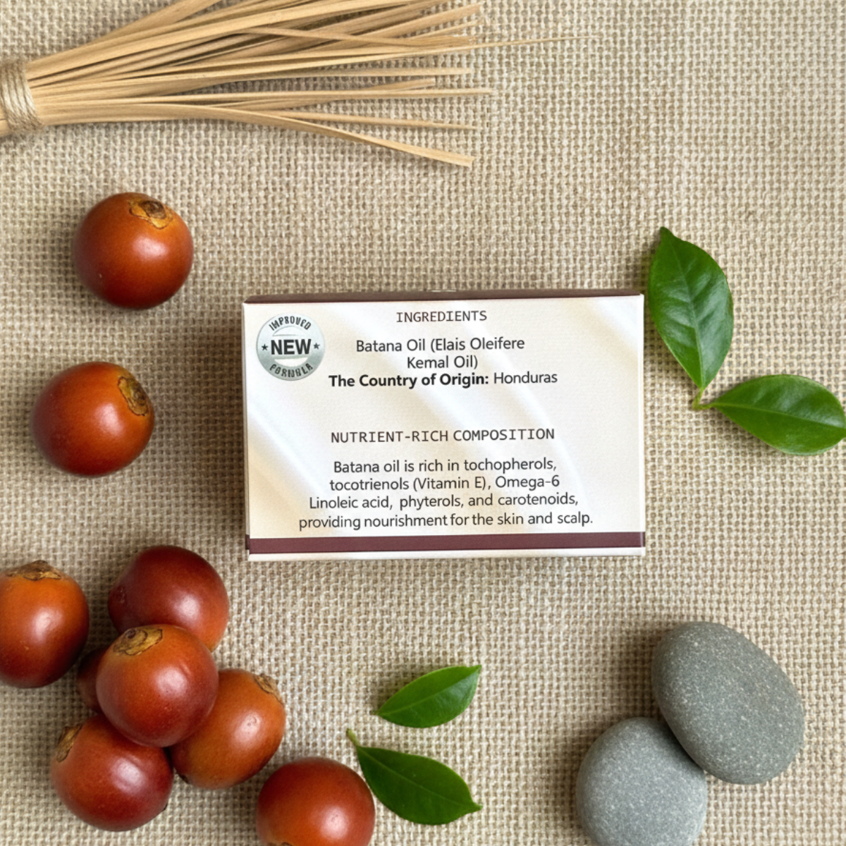 An information card for Batana Oil is displayed with fruits, leaves, and stones on a burlap background.
