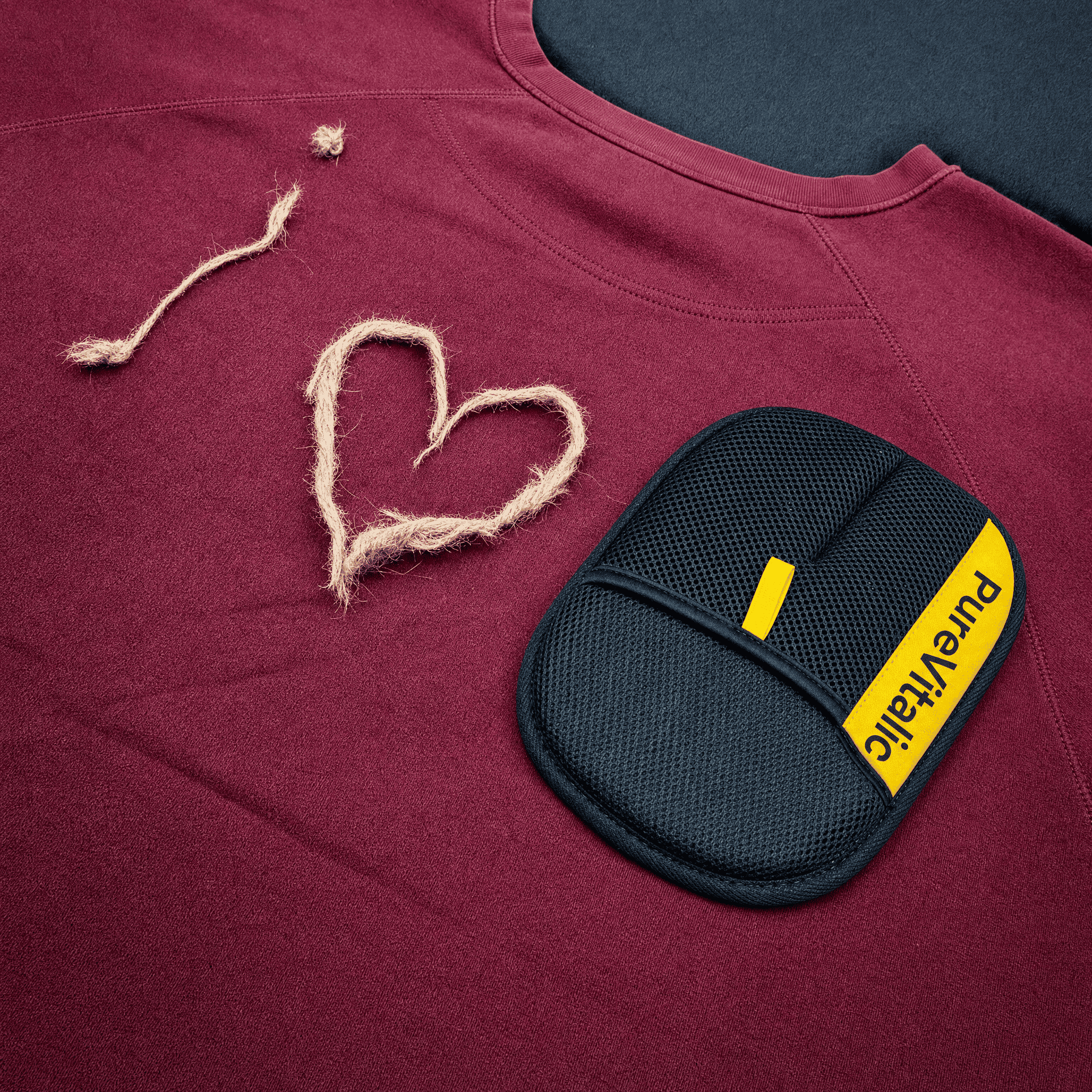 'I love' spelled in twine next to a black PureVitalic mesh pad on a burgundy sweatshirt.