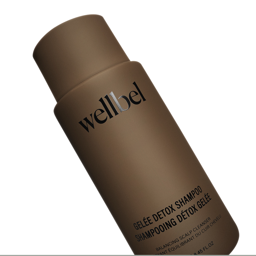 Brown bottle labeled 'wellbel Gelée Detox Shampoo' on a black background.