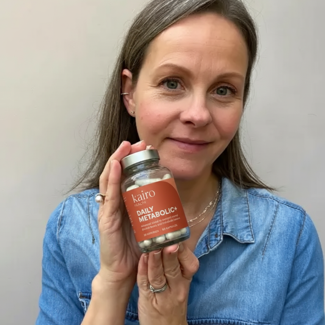Person holding a bottle of daily metabolic capsules.