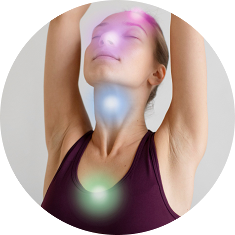 Person in yoga pose with colorful light orbs on body.