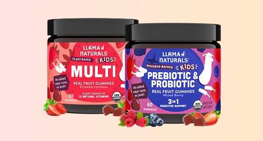 Two jars of Llama Naturals kids' vitamin gummies surrounded by fresh berries and gummies.