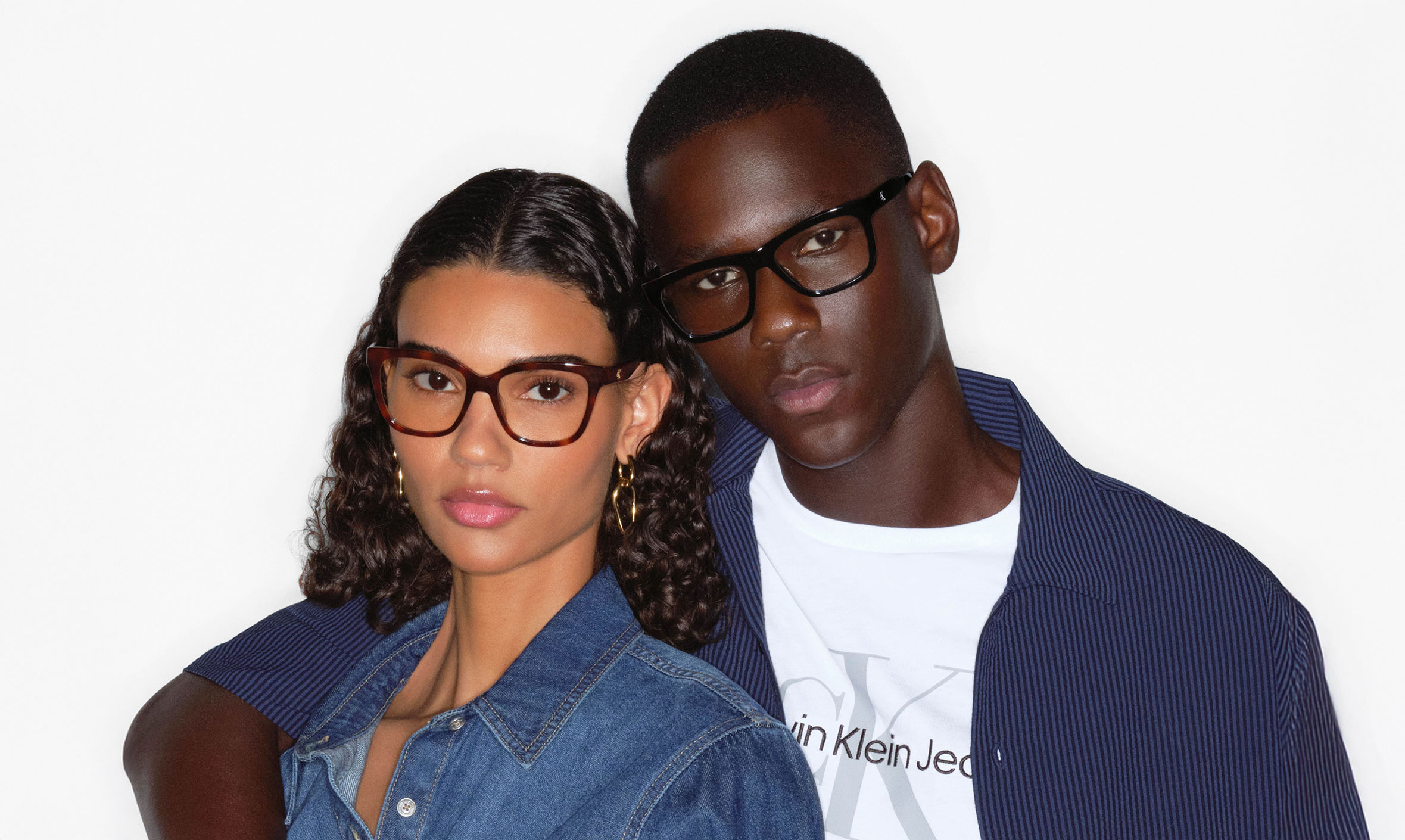 Young stylish couple, male and female, wearing Calvin Klein Jeans eye frames.