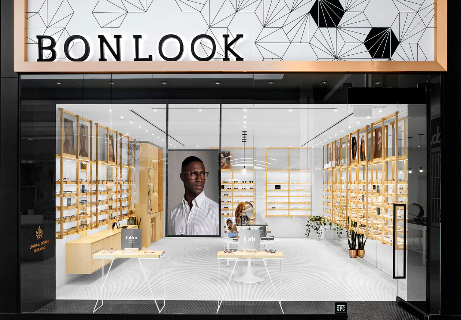 Modern BonLook eyewear store with wooden shelves and geometric wall designs.k 