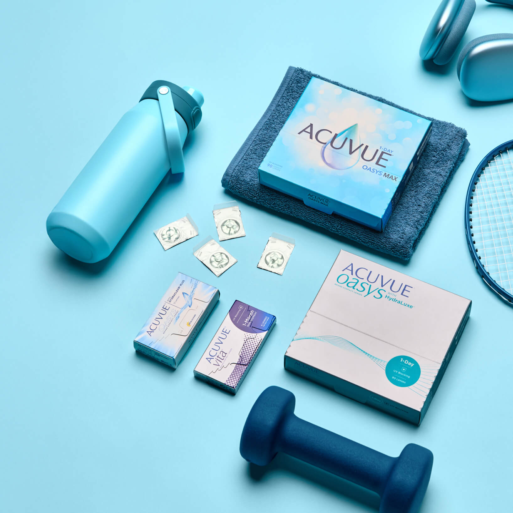 Contact lens products, water bottle, towel, dumbbell, and racket on a blue background.