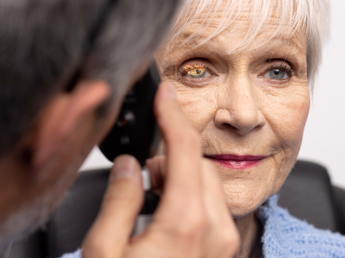Optometrist performing a cataract screening during a comprehensive eye exam