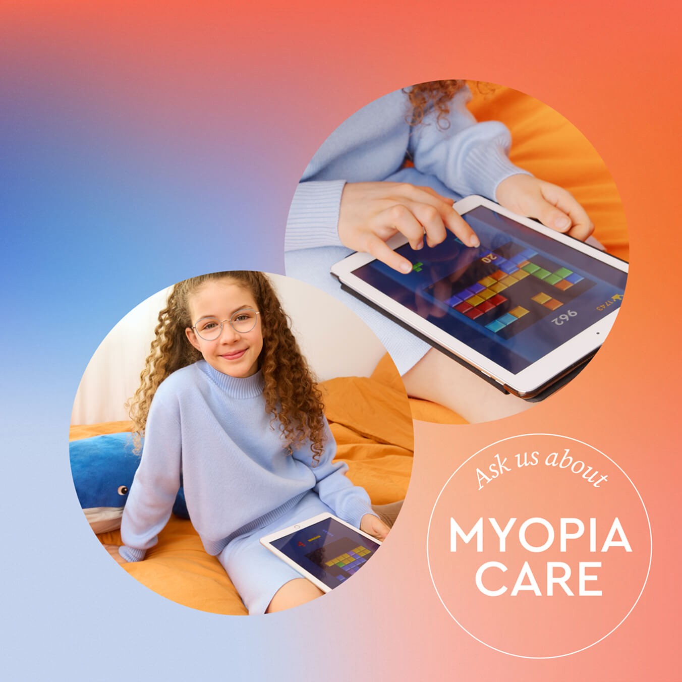 Girl in blue sweater playing a game on a tablet, sitting on an orange bed.