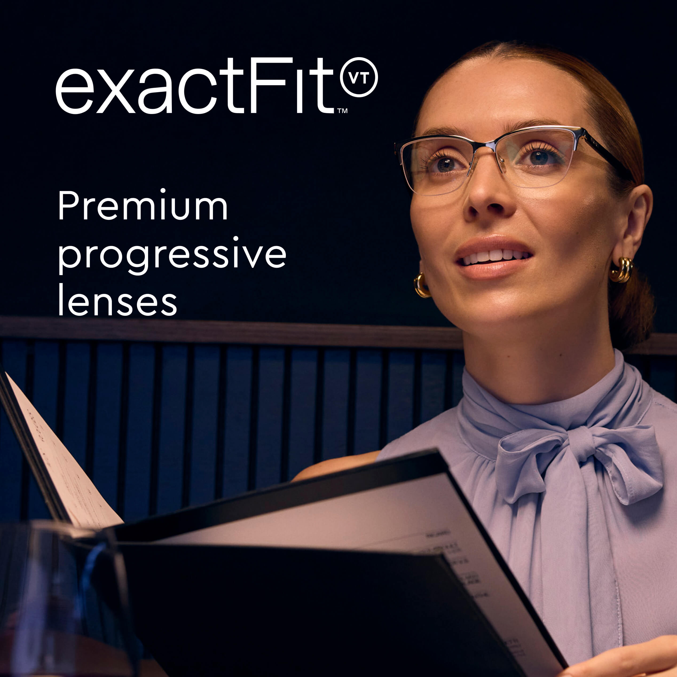 A woman wearing glasses and a purple blouse looks up from a menu in a dimly lit restaurant.