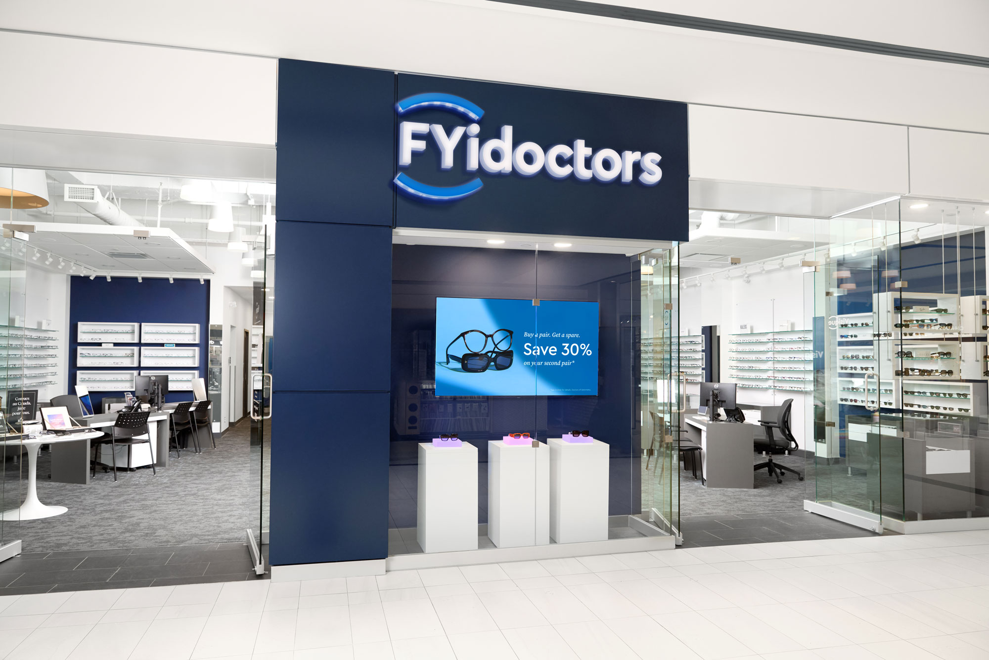 FYidoctors clinic storefront with eyeglasses display and promotional sign.