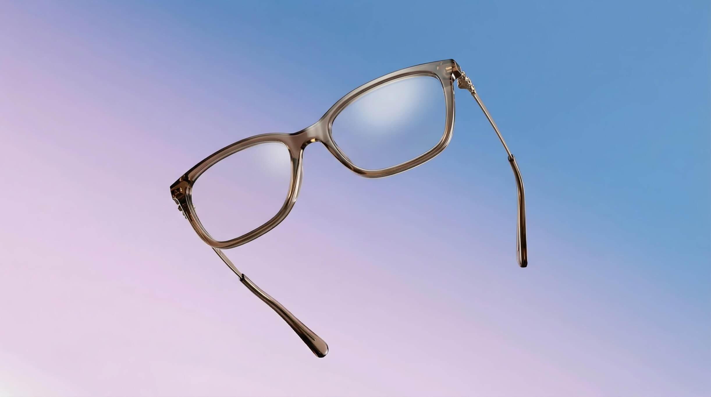 A pair of brown-framed eyeglasses floating against a purple and blue gradient background.