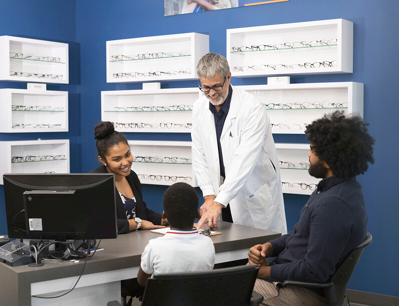 Father and child having an appointment at FYidoctors, talking to eye-doctor