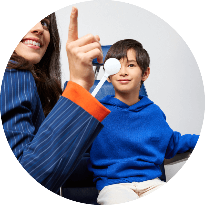 Male child doing a myopia exam with an optometrist