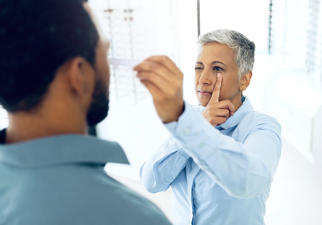 Optometrist doing an eye exam to assess if patient is a candidate for contact lens use