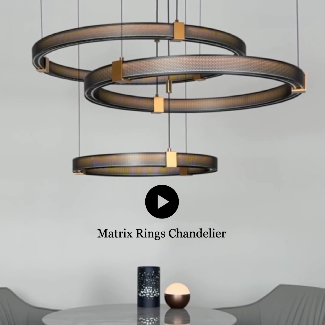 Three-ring chandelier with gold accents above a table with decorative items.
