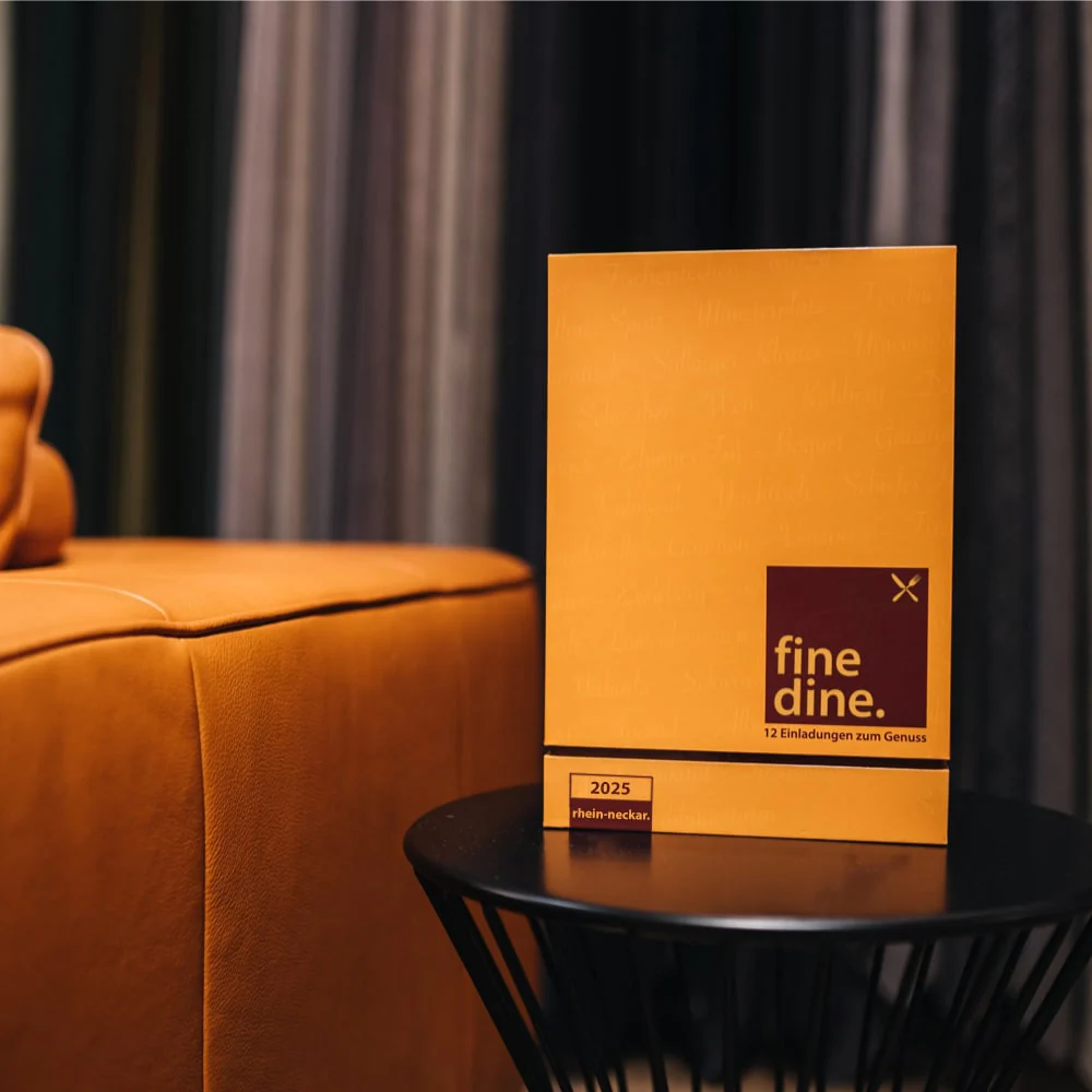 Orange booklet on a table beside a matching couch.