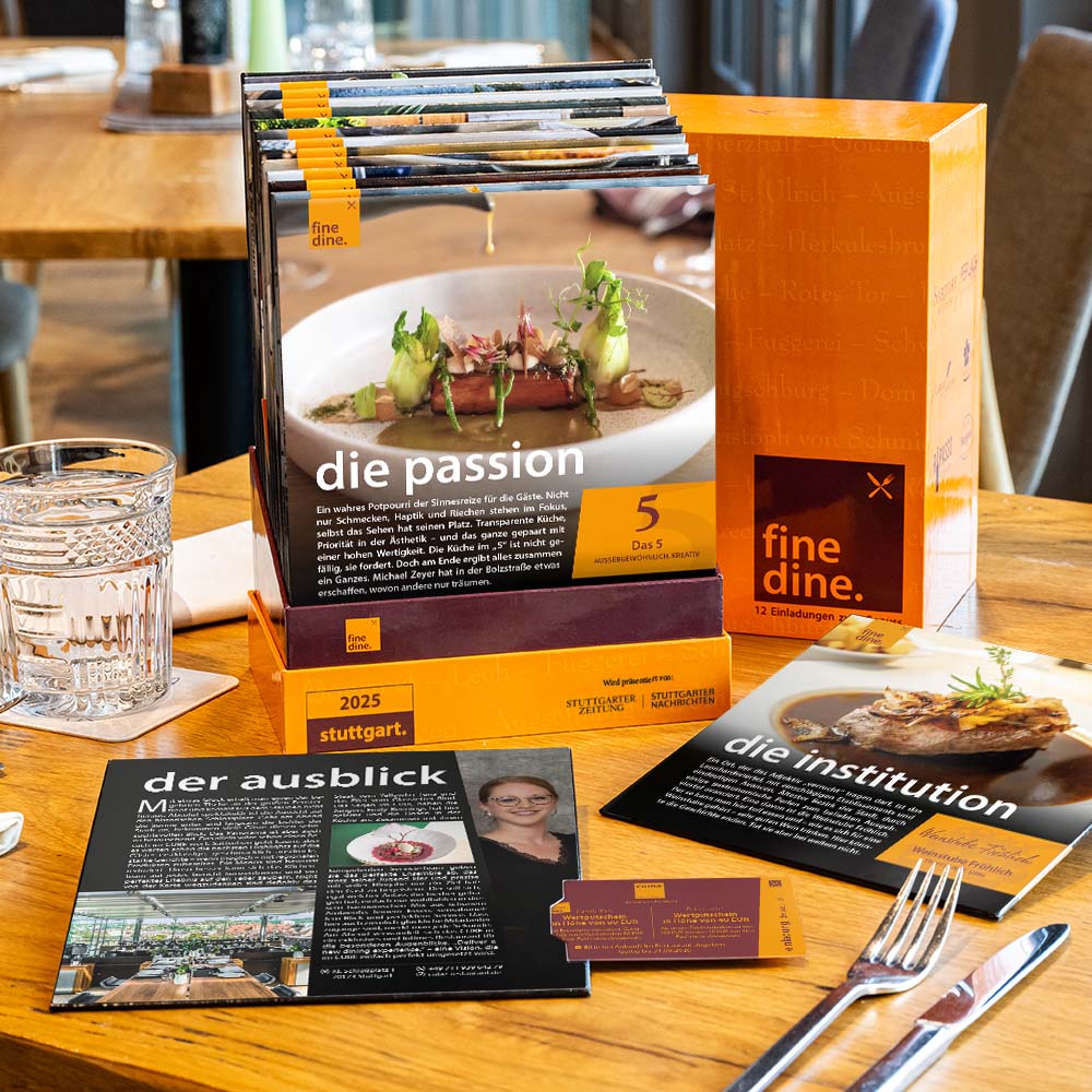 Promotional materials on a restaurant table featuring food photography and dining information.