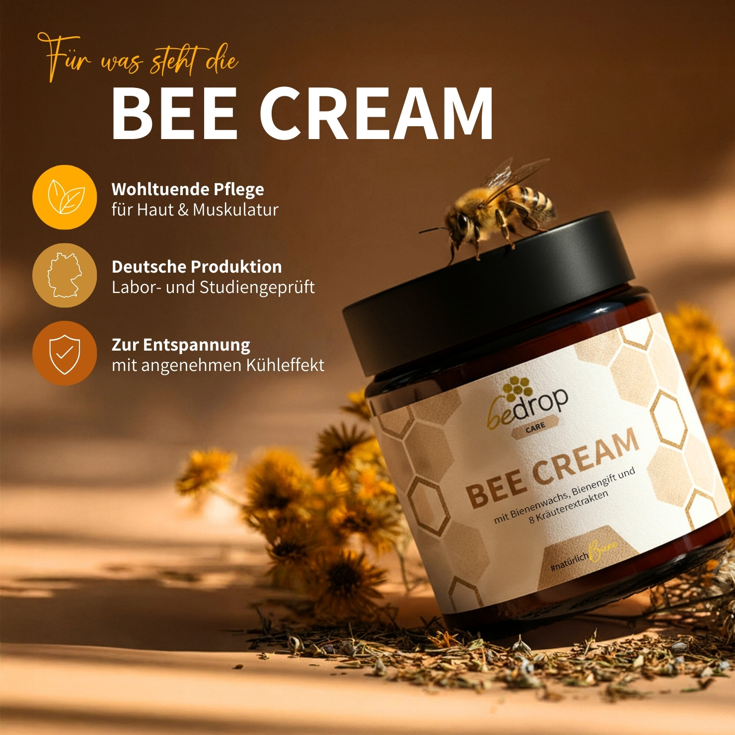 A jar of Bee Cream with a bee on the lid, surrounded by dried herbs and yellow flowers.